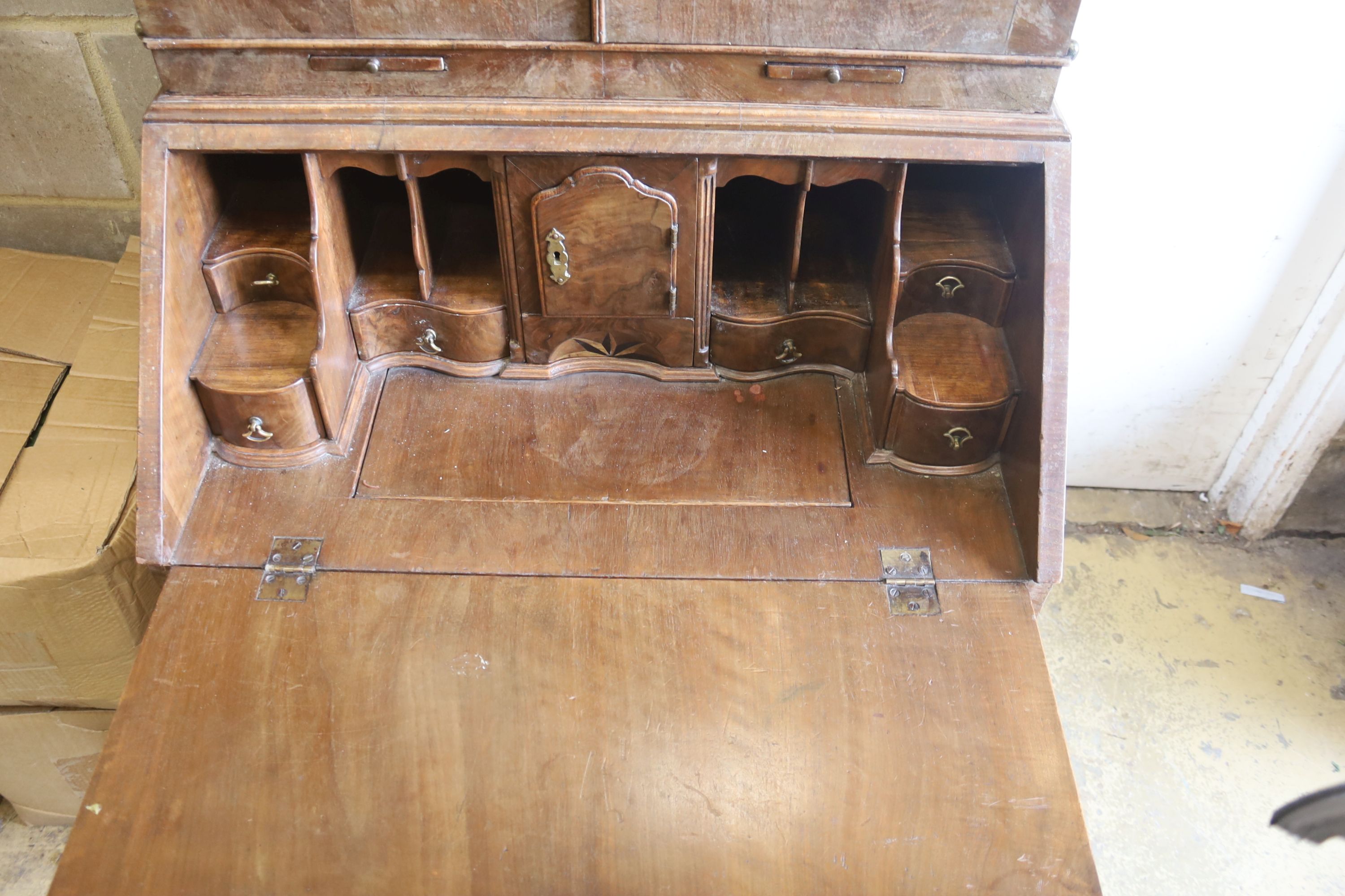 A Queen Anne style walnut double domed top bureau bookcase, length 72cm, width 50cm, height 196cm